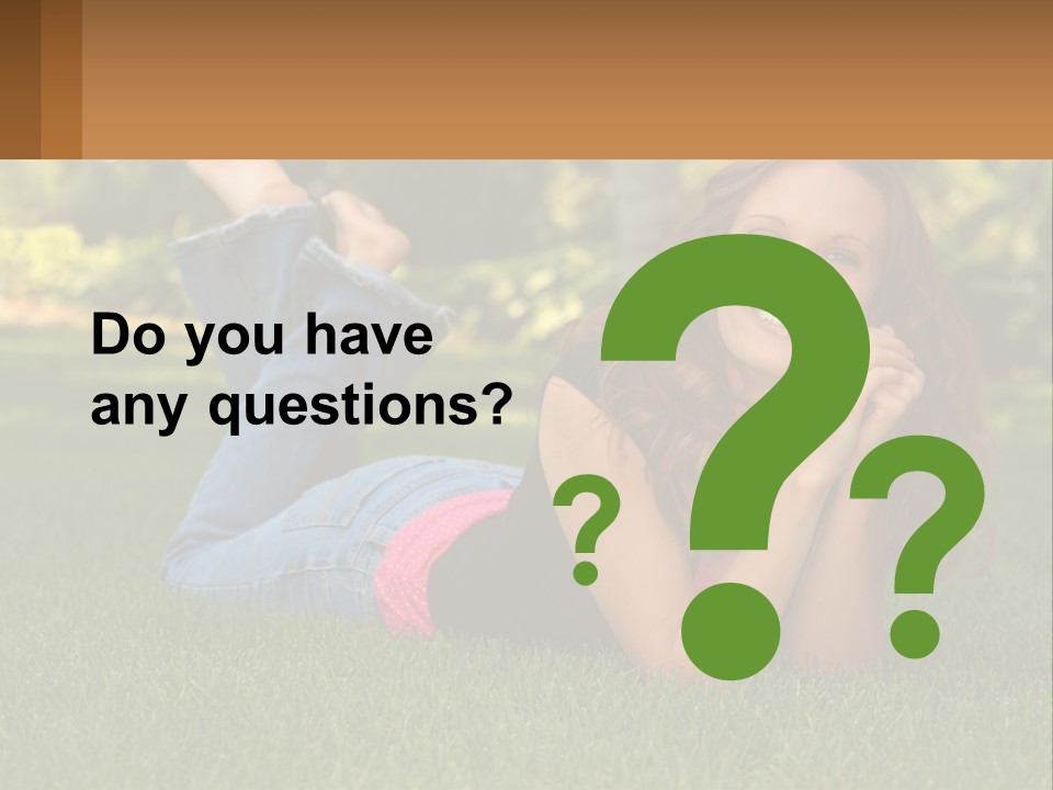 A Beautiful Woman Laying On The Grass In A Park PowerPoint Template