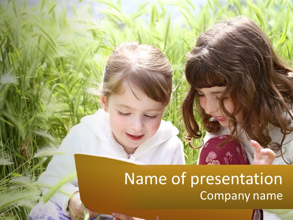 Two Little Girls Are Looking At A Book PowerPoint Template