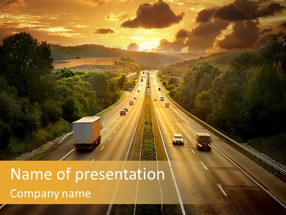 A Highway With Cars Driving Down It At Sunset PowerPoint Template
