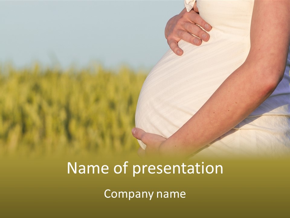 A Pregnant Woman Holding Her Belly In A Field PowerPoint Template