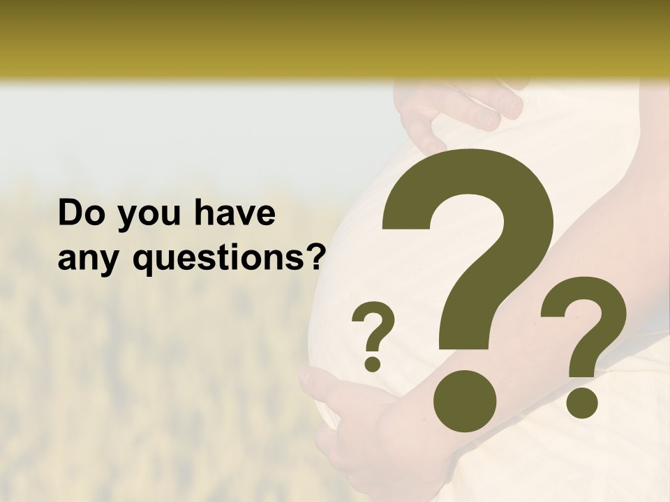 A Pregnant Woman Holding Her Belly In A Field PowerPoint Template