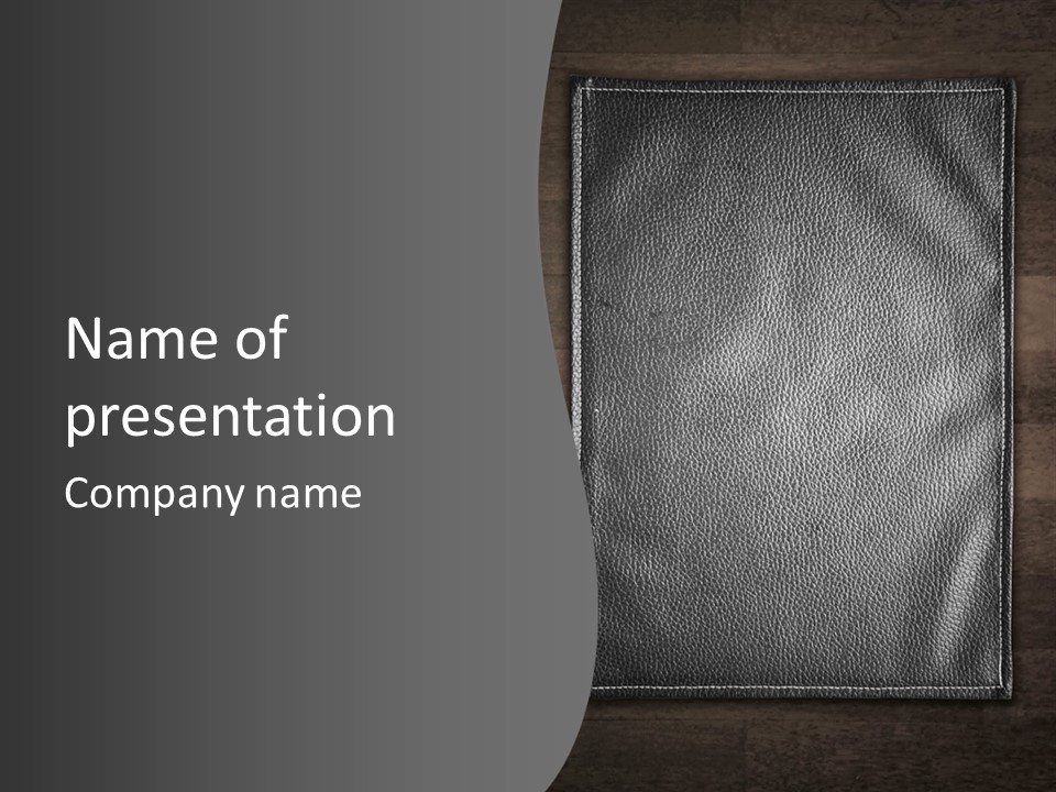 A Black Leather Book On A Wooden Table PowerPoint Template