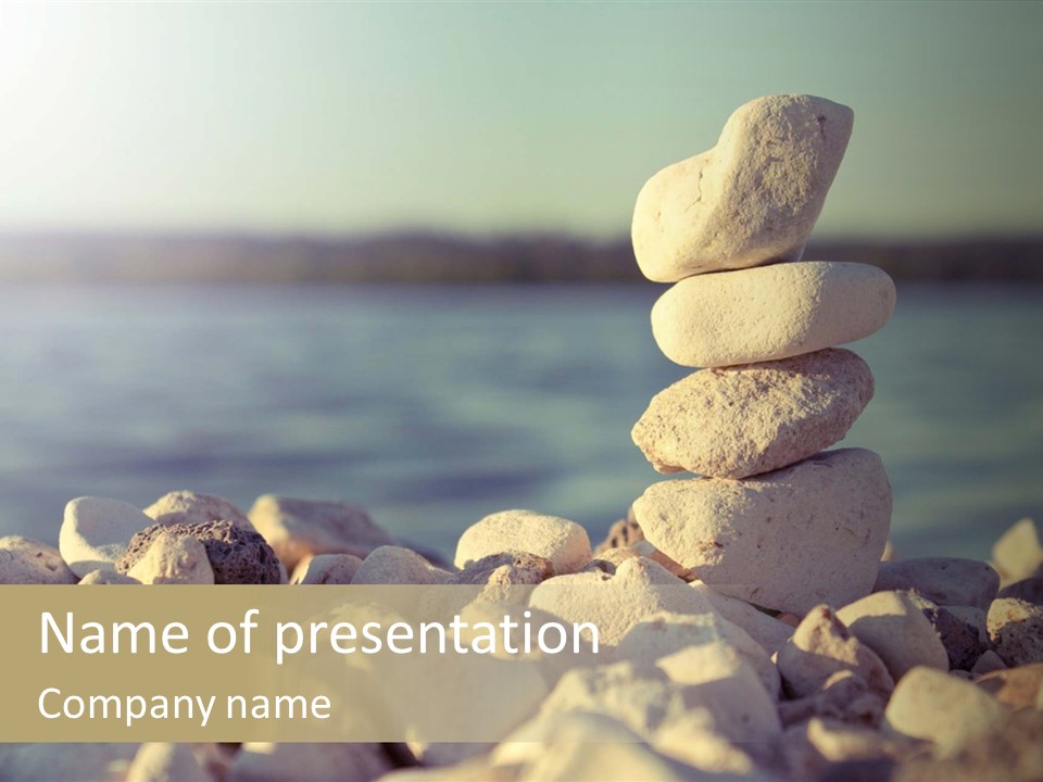 A Pile Of Rocks Sitting On Top Of A Beach PowerPoint Template
