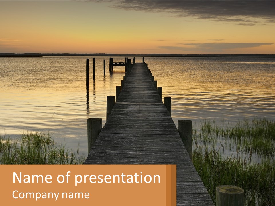 A Wooden Dock In The Middle Of A Body Of Water PowerPoint Template