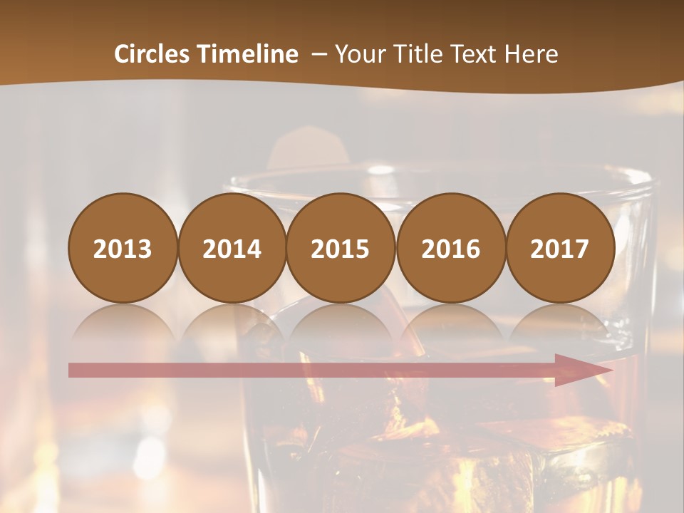 A Glass Of Whiskey With Ice On A Table PowerPoint Template