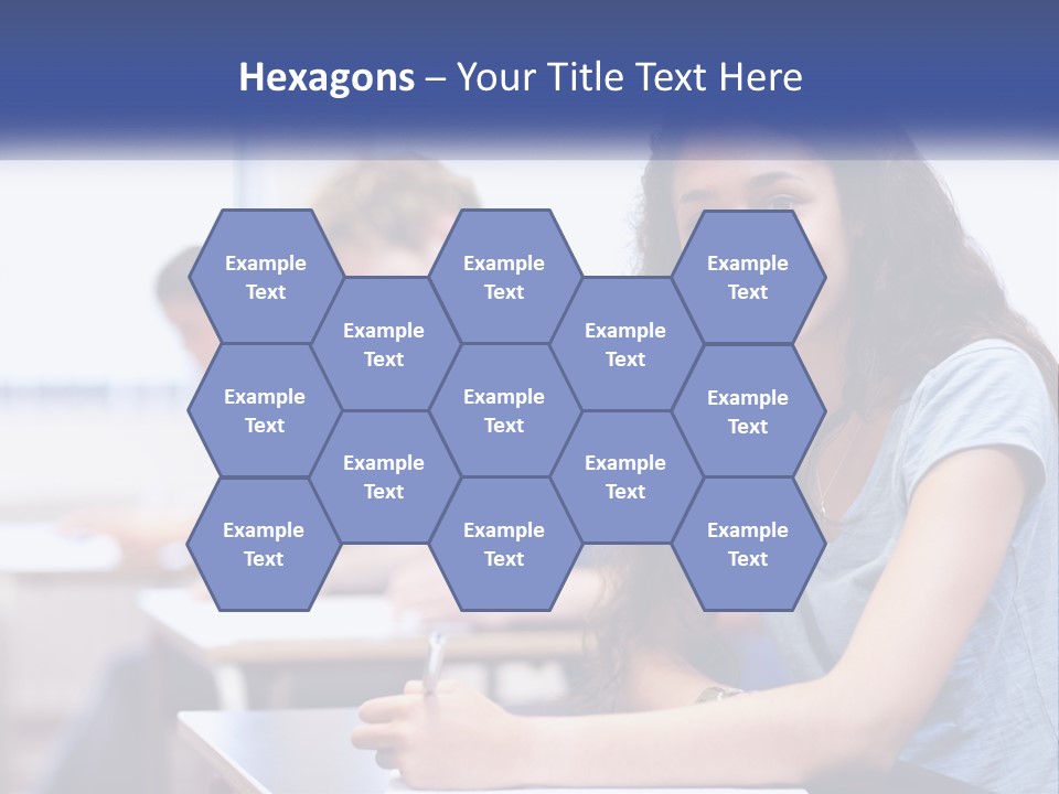 A Woman Sitting At A Desk In A Classroom PowerPoint Template