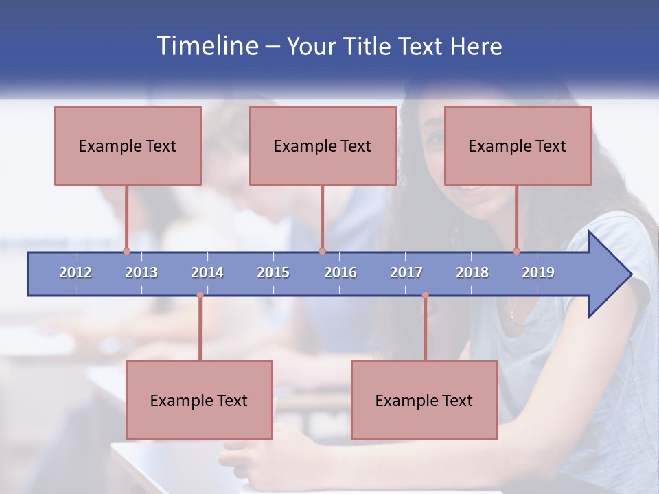 A Woman Sitting At A Desk In A Classroom PowerPoint Template