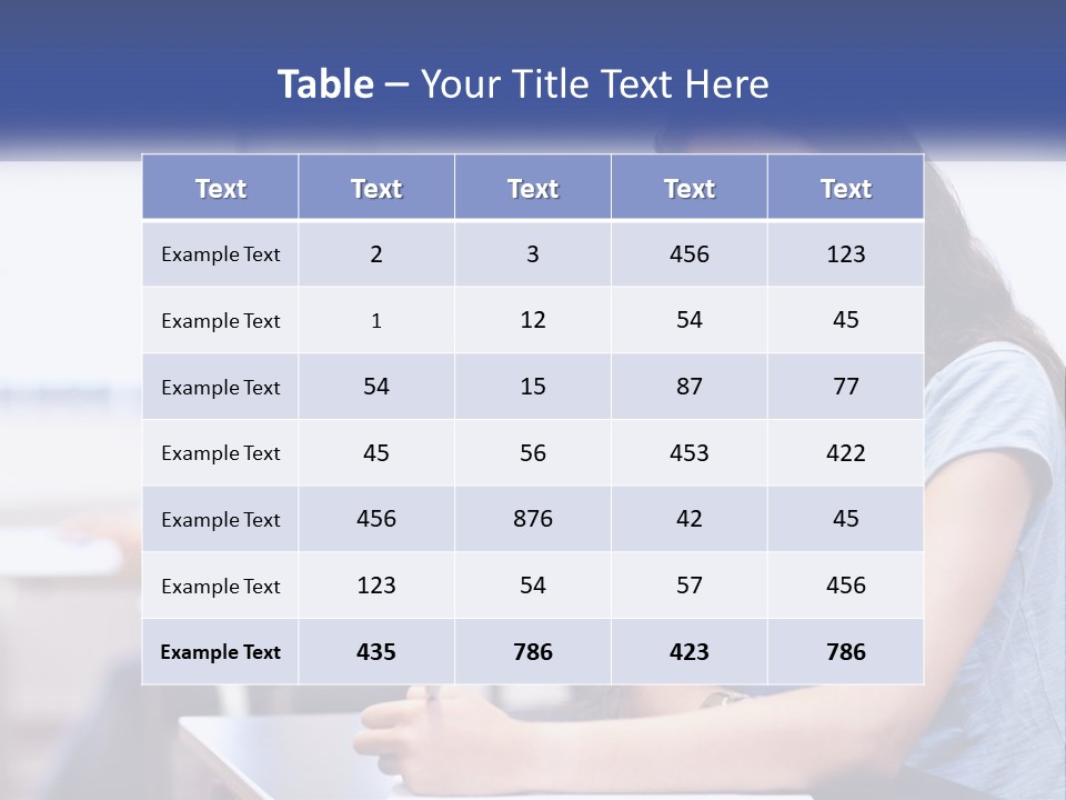 A Woman Sitting At A Desk In A Classroom PowerPoint Template