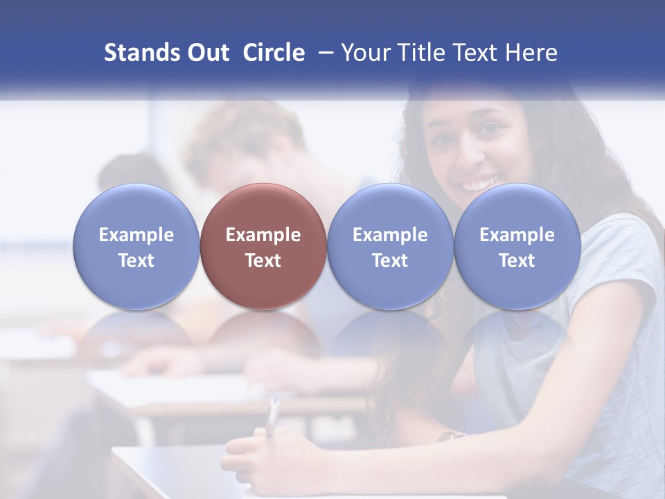 A Woman Sitting At A Desk In A Classroom PowerPoint Template