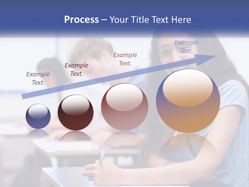 A Woman Sitting At A Desk In A Classroom PowerPoint Template
