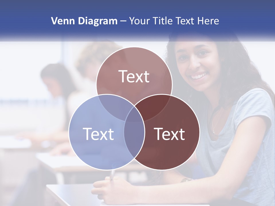 A Woman Sitting At A Desk In A Classroom PowerPoint Template