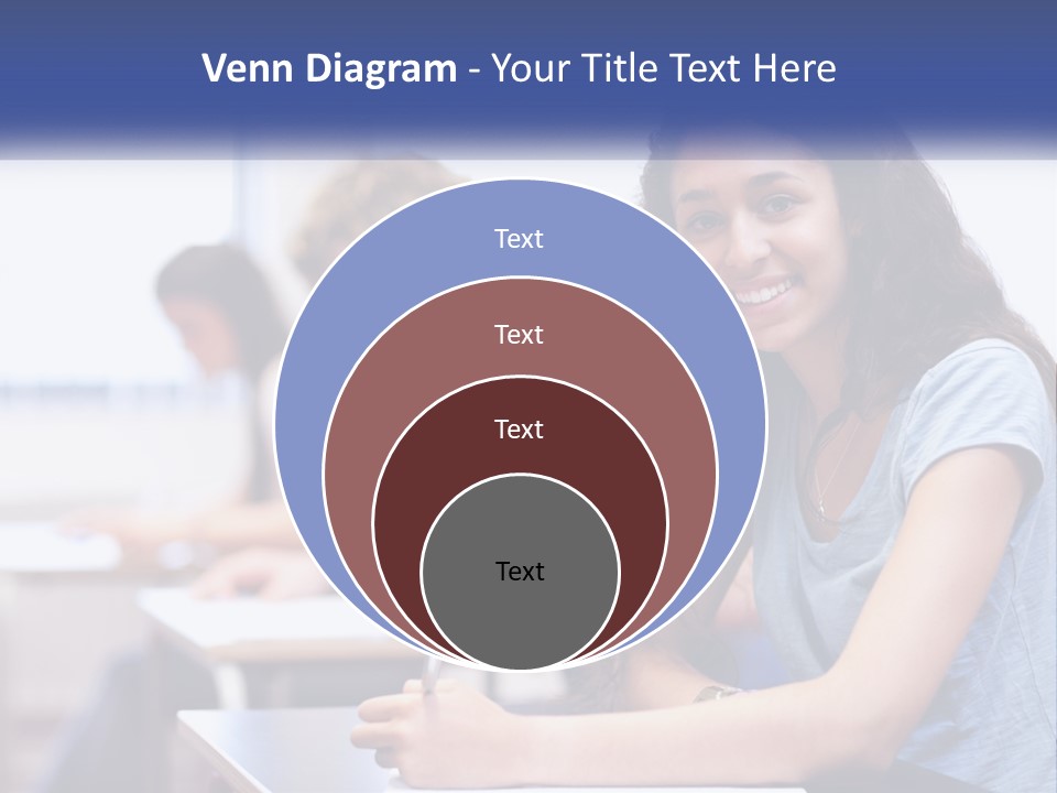 A Woman Sitting At A Desk In A Classroom PowerPoint Template