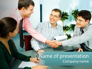 A Group Of People Sitting Around A Table Shaking Hands PowerPoint Template