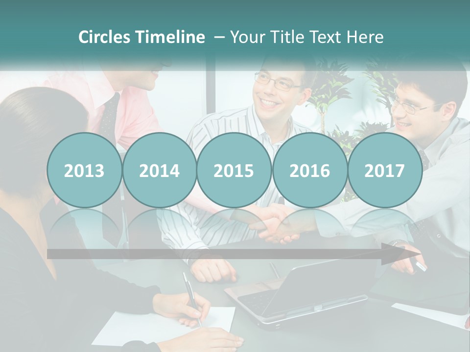 A Group Of People Sitting Around A Table Shaking Hands PowerPoint Template