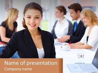 A Woman Sitting At A Table In Front Of A Laptop PowerPoint Template