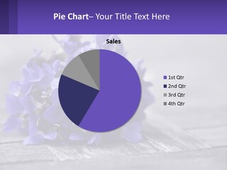 A Bunch Of Purple Flowers Sitting On Top Of A Wooden Table PowerPoint Template