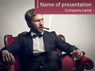 A Man Sitting In A Chair With A Cigarette In His Mouth PowerPoint Template