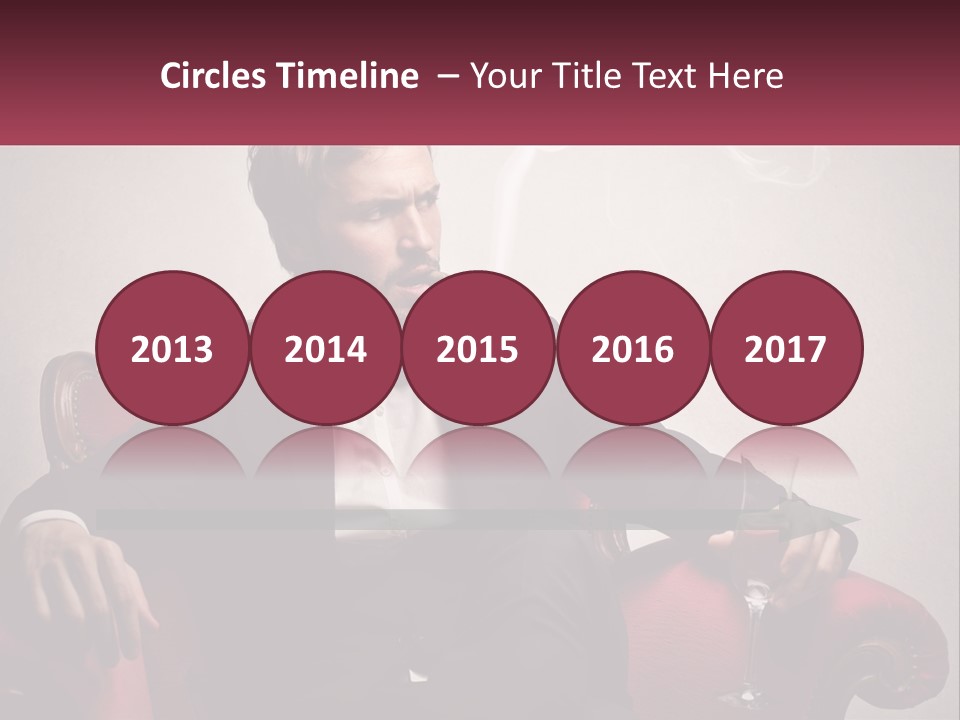 A Man Sitting In A Chair With A Cigarette In His Mouth PowerPoint Template