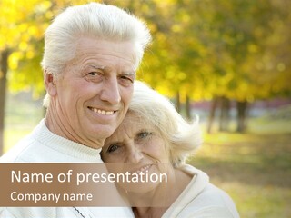 An Elderly Couple Is Smiling For The Camera PowerPoint Template