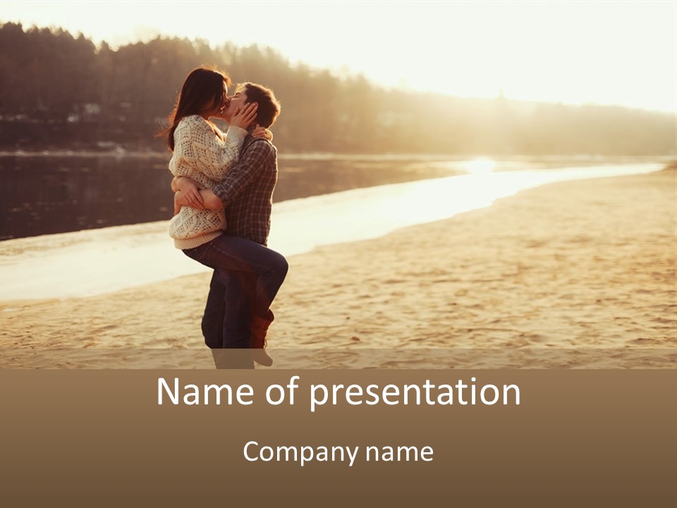 A Couple Kissing On The Beach In Front Of A Body Of Water PowerPoint Template