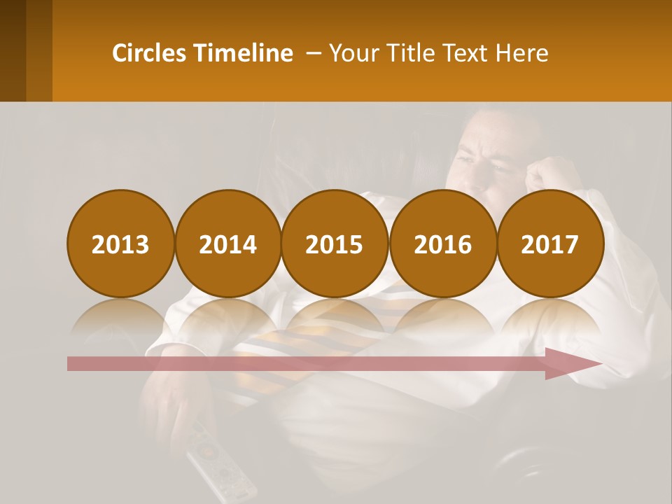 A Man Sitting On A Couch With A Tie On PowerPoint Template
