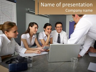 A Group Of People Sitting Around A Laptop Computer PowerPoint Template