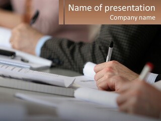 A Group Of People Sitting At A Table With Notebooks And Pens PowerPoint Template