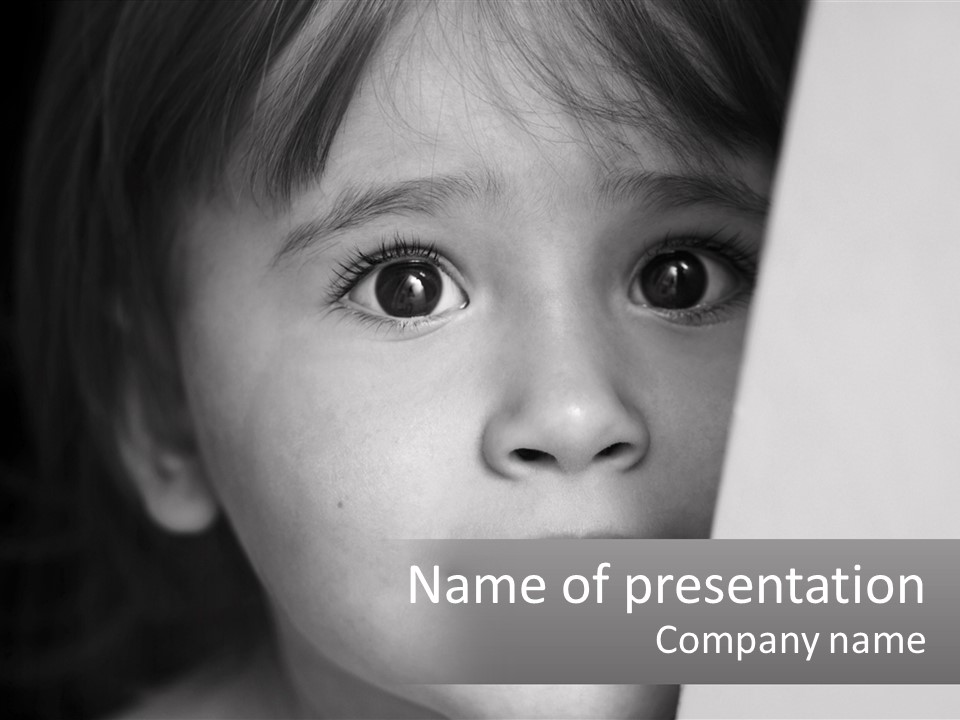A Little Girl Looking Over A Wall With Her Eyes Wide Open PowerPoint Template