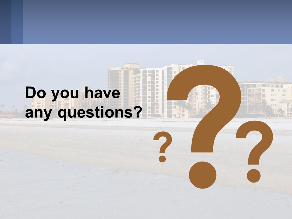 A Sandy Beach With Buildings In The Background PowerPoint Template