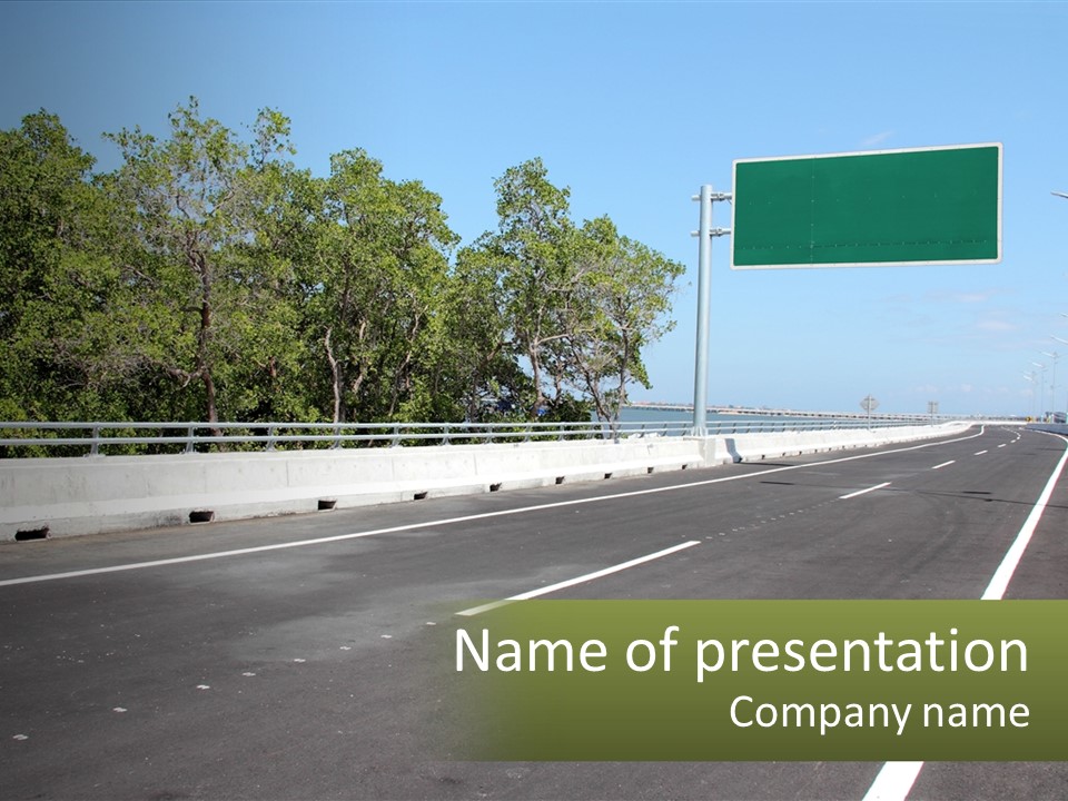 A Highway With A Green Sign On The Side Of It PowerPoint Template