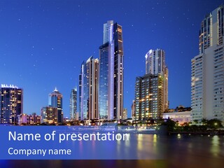 A City At Night With Skyscrapers In The Background PowerPoint Template