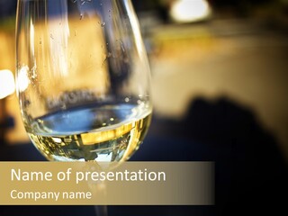 A Glass Of White Wine On A Table PowerPoint Template