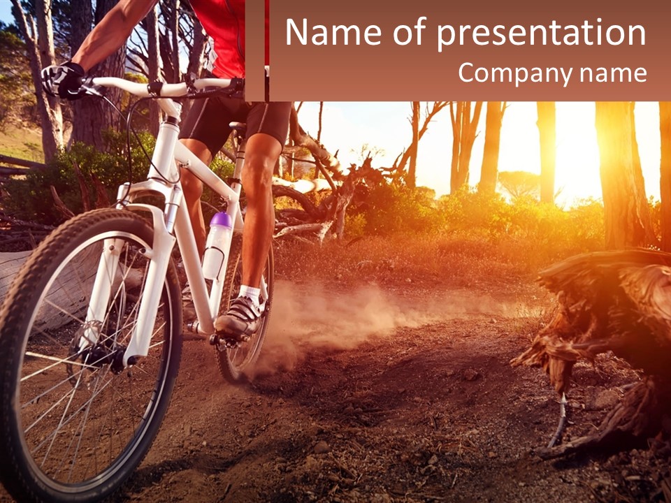 A Person Riding A Bike On A Dirt Road PowerPoint Template