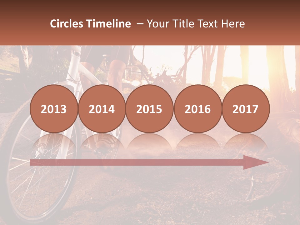 A Person Riding A Bike On A Dirt Road PowerPoint Template