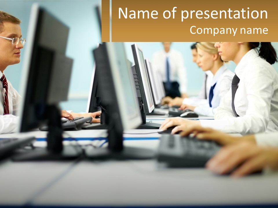 A Group Of People Working On Computers In An Office PowerPoint Template