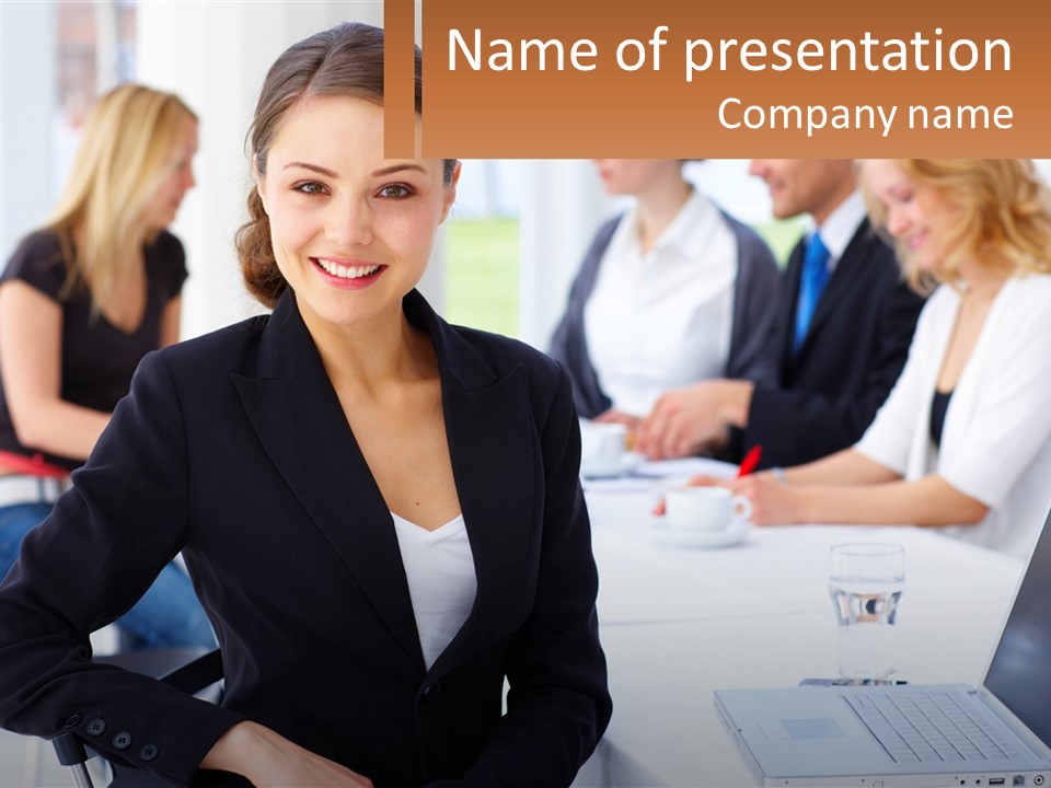 A Woman Sitting At A Table In Front Of A Group Of People PowerPoint Template