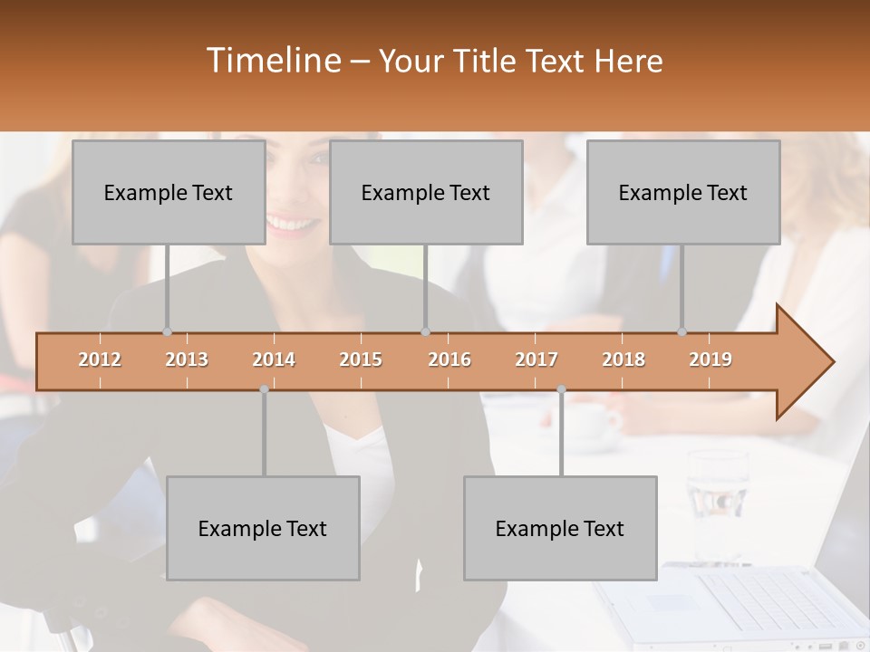 A Woman Sitting At A Table In Front Of A Group Of People PowerPoint Template