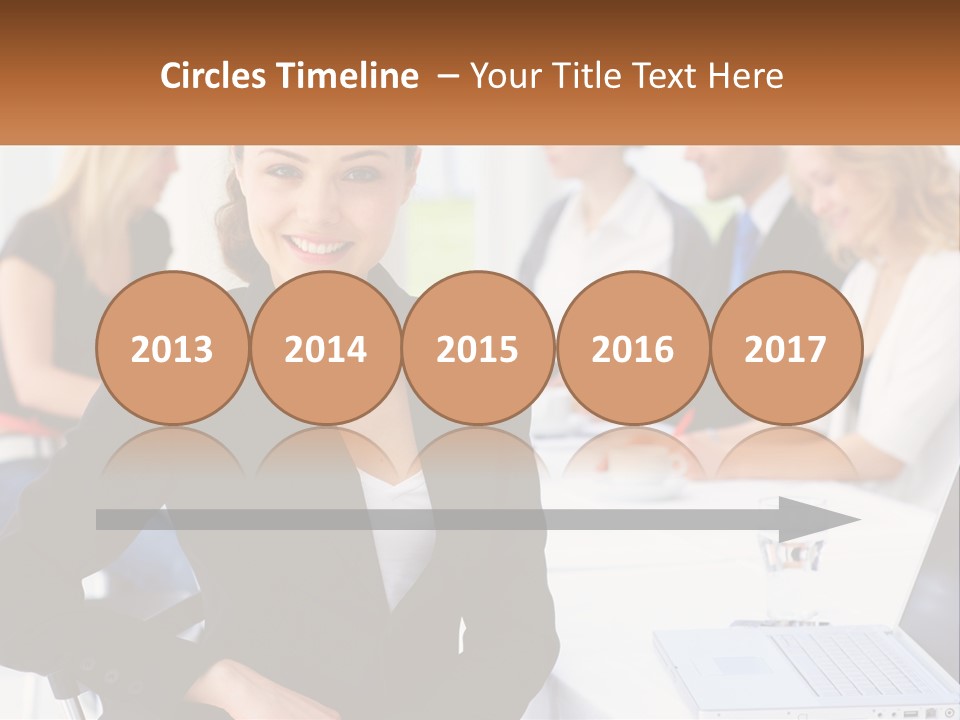 A Woman Sitting At A Table In Front Of A Group Of People PowerPoint Template