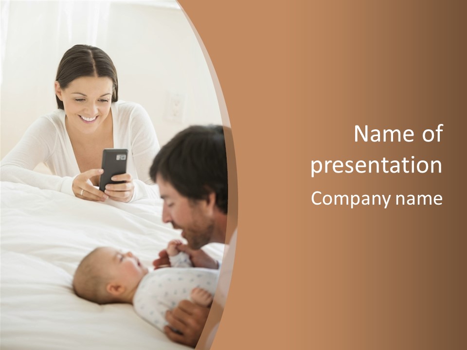 A Man And Woman Looking At A Cell Phone While Holding A Baby PowerPoint Template