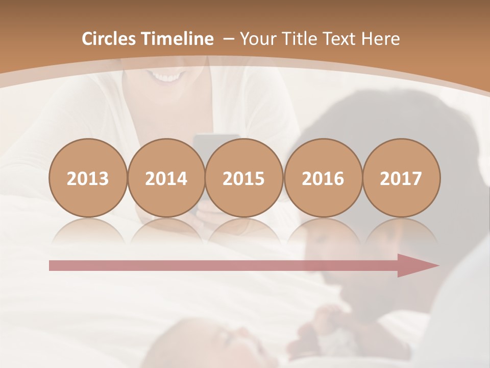 A Man And Woman Looking At A Cell Phone While Holding A Baby PowerPoint Template