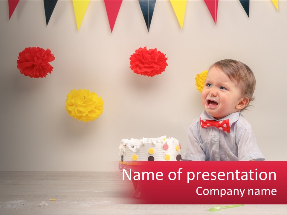 A Baby Boy Sitting In Front Of A Cake PowerPoint Template