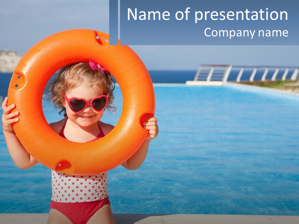 A Little Girl Holding An Orange Life Preserver In Front Of A Swimming Pool PowerPoint Template