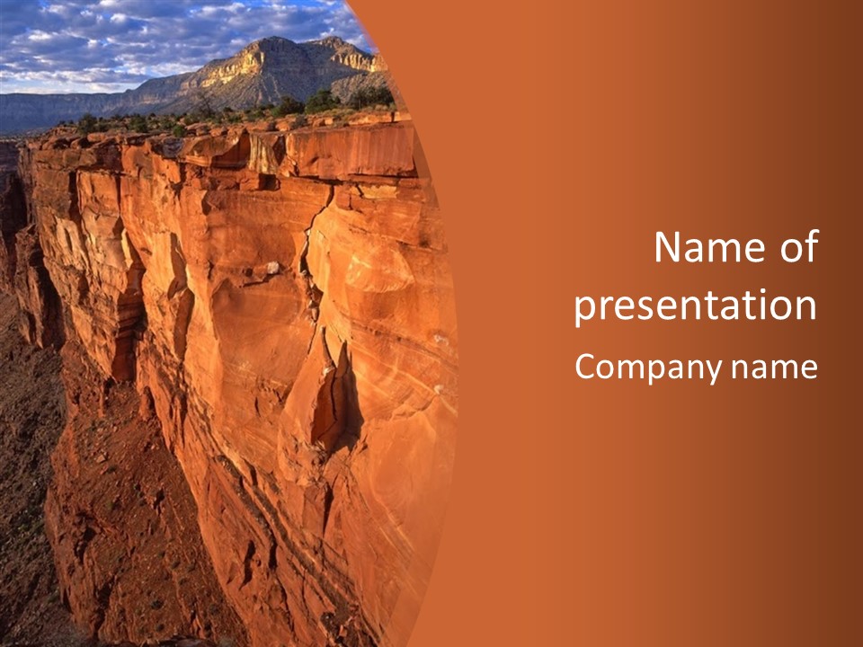 A Rocky Cliff With A Mountain In The Background PowerPoint Template