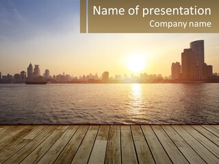 A Wooden Deck Overlooking A Body Of Water With A City In The Background PowerPoint Template
