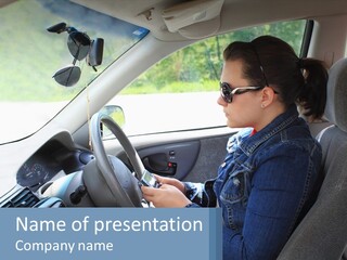 A Woman Sitting In A Car With A Steering Wheel PowerPoint Template