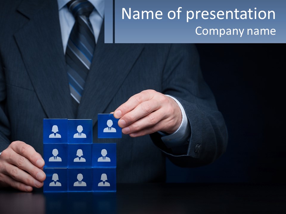 A Man In A Suit Holding A Block Of Blue Paper With A Group Of People PowerPoint Template