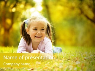 A Little Girl Laying On The Grass In A Park PowerPoint Template