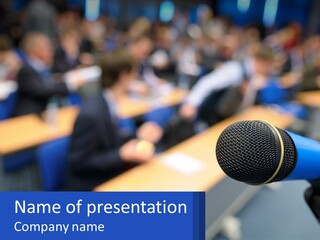 A Microphone In Front Of A Lecture Hall Full Of People PowerPoint Template