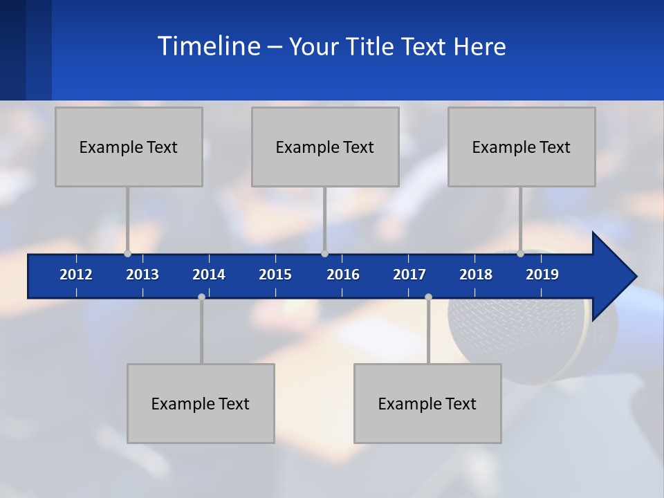 A Microphone In Front Of A Lecture Hall Full Of People PowerPoint Template