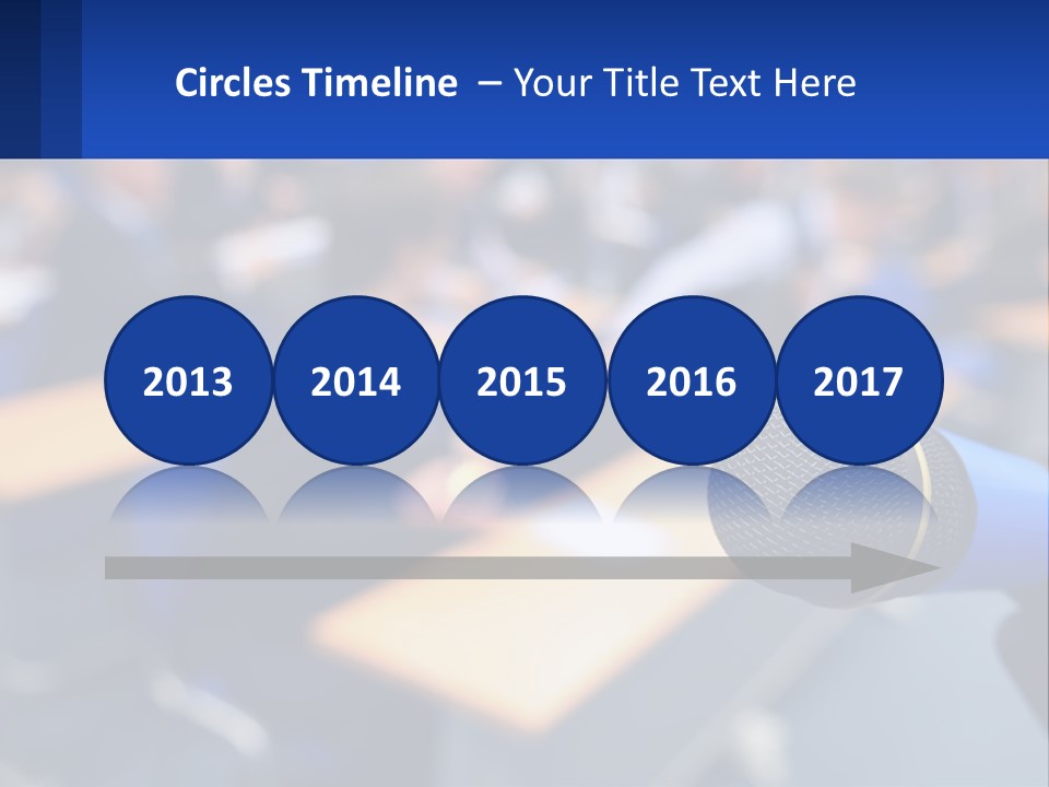 A Microphone In Front Of A Lecture Hall Full Of People PowerPoint Template